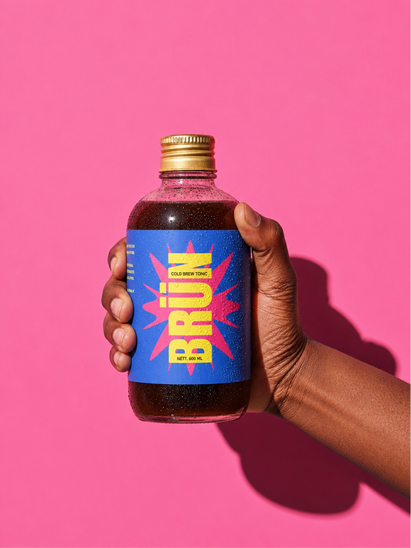 Hand holding an ice-cold Tonic bottle